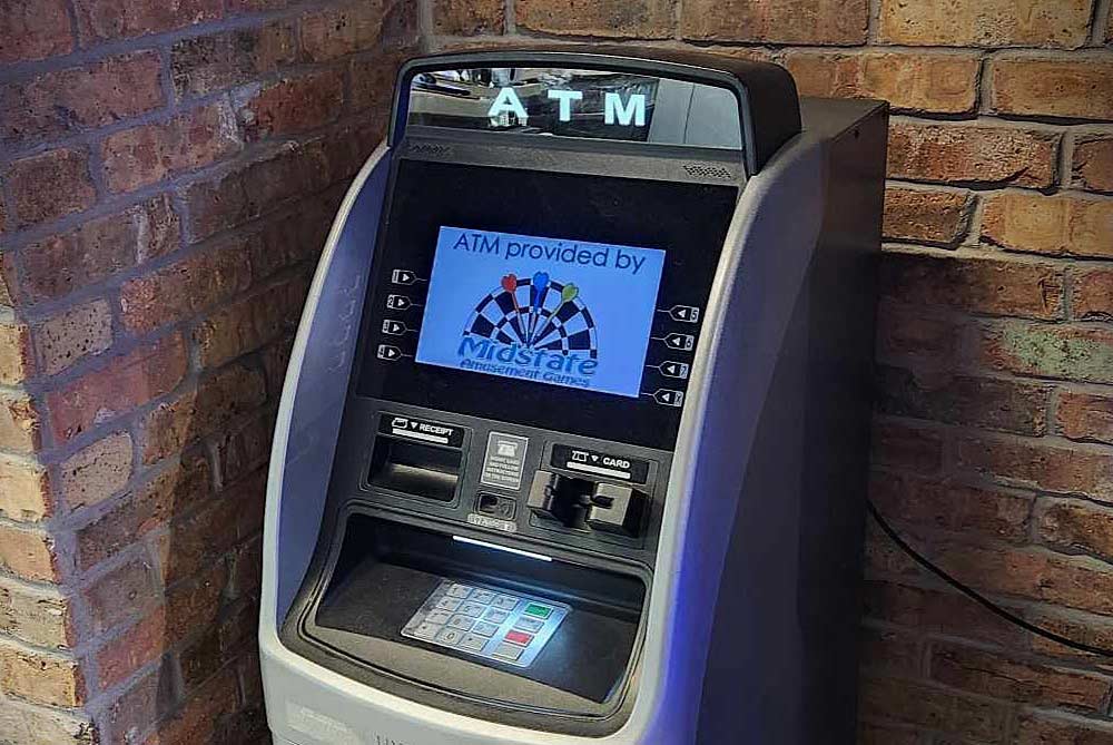 ATM cash machine against a brick wall in WI business.