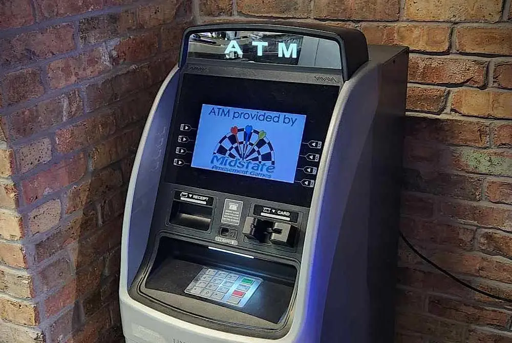 ATM cash machine against a brick wall in WI business.